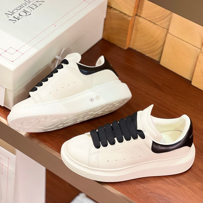 OVERSIZED SNEAKERS IN WHITE CALFSKIN BLACK HEEL BLACK LACES