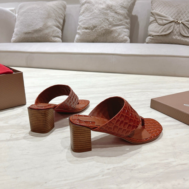 EMBOIDERED LOGO MULES IN COGNAC BROWN EMBOSSED CALFSKIN