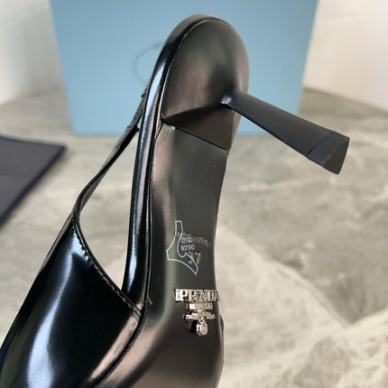 PRADA 25S METAL-TOE SLINGBACK PUMPS IN BLACK CALFSKIN