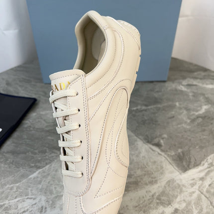 PRADA 25S MONTECARLO ANTIQUED SNEAKERS IN CHALK WHITE NAPPA LEATHER