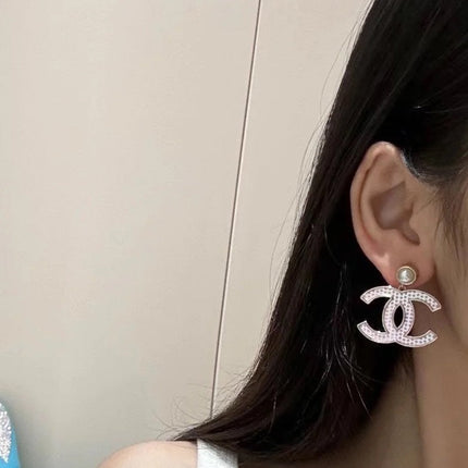 DOUBLE C EARRINGS IN SILVER METAL WITH BLACK SNOWFLAKE EMBOSSED ON WHITE ENAMEL