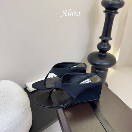 ALAIA WEDGE THONG SANDALS 25S IN BLACK SATIN