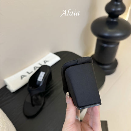 ALAIA WEDGE THONG SANDALS 25S IN BLACK SATIN