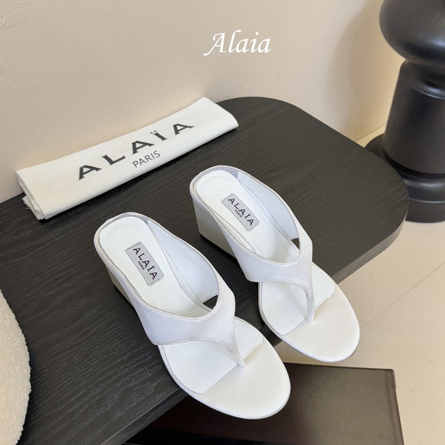 ALAIA WEDGE THONG SANDALS 25S IN WHITE SATIN
