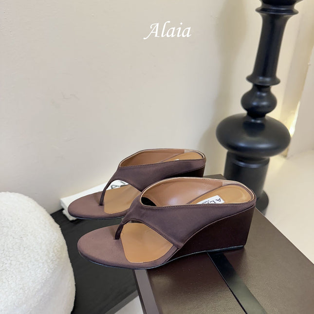 ALAIA WEDGE THONG SANDALS 25S IN BROWN SATIN