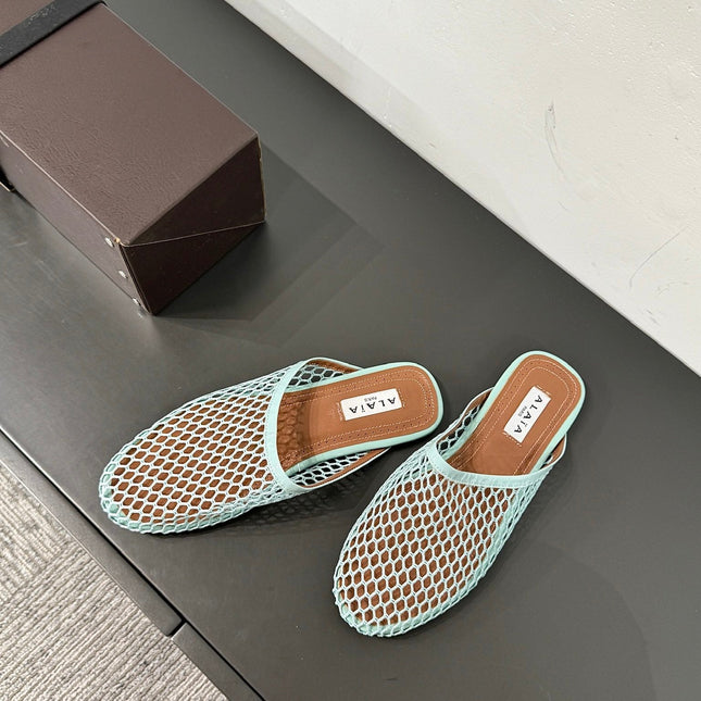 ALAIA FLAT MULES IN LIGHT BLUE MESH FISHNET
