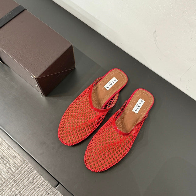 ALAIA FLAT MULES IN CHERRY RED MESH FISHNET