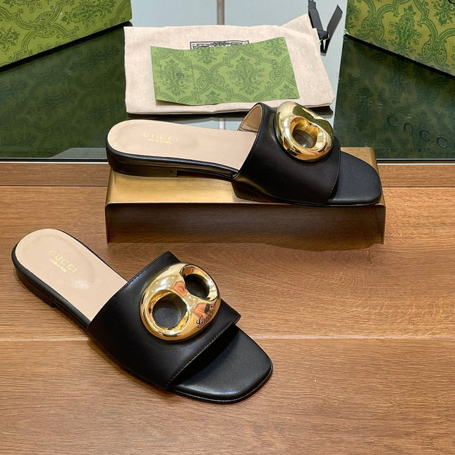 FLAT MULE IN BLACK CALFSKIN WITH GOLD HARDWARE