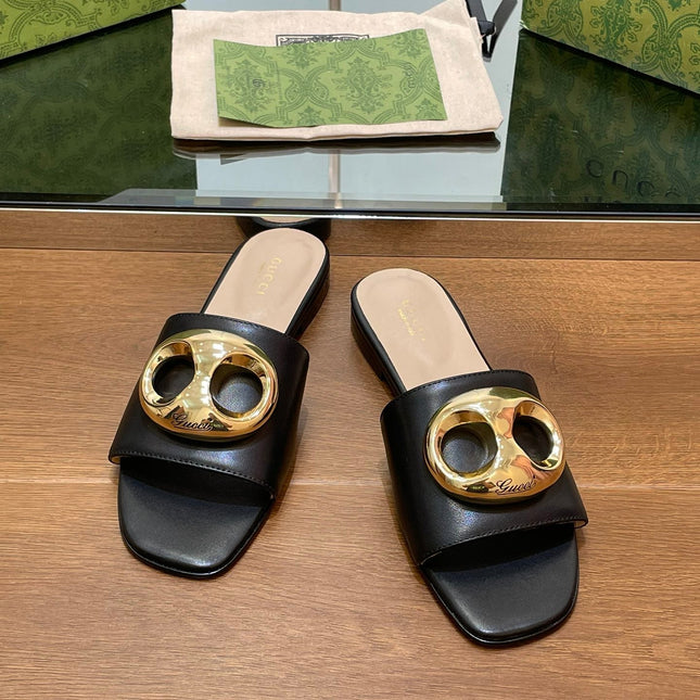 FLAT MULE IN BLACK CALFSKIN WITH GOLD HARDWARE