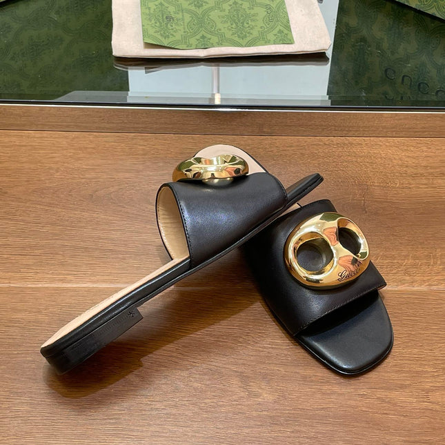 FLAT MULE IN BLACK CALFSKIN WITH GOLD HARDWARE