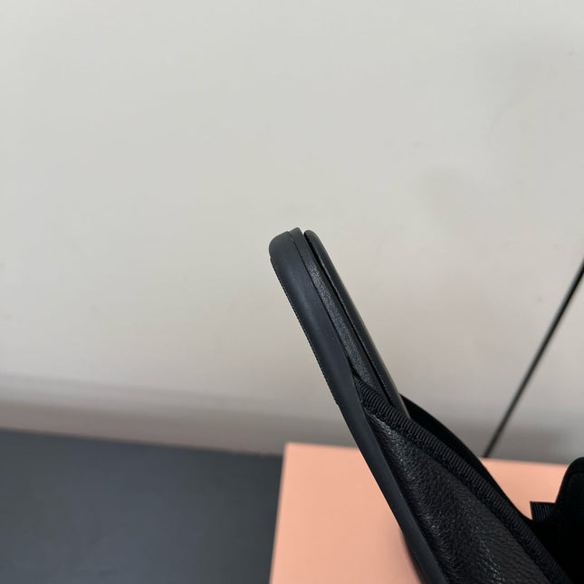 BOW MULES IN BLACK SHEEPSKIN