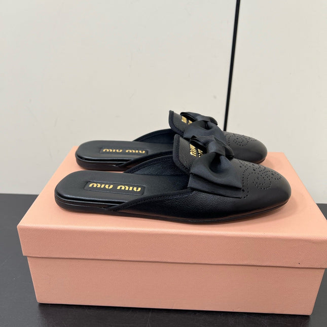 BOW MULES IN BLACK SHEEPSKIN