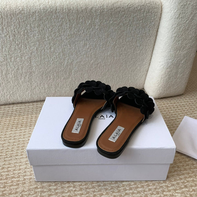 ALAIA FLAT MULE IN BLACK SUEDE
