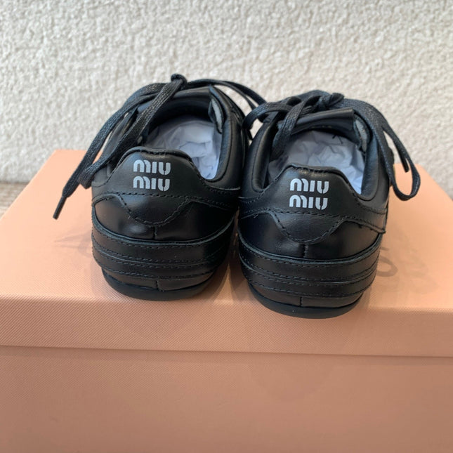 GYMNASIUM SNEAKER IN BLACK CALFSKIN WITH GOLD BUCKLED STRAP