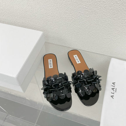 ALAIA FLAT MULE IN BLACK GLOSSY LAMBSKIN