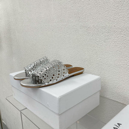 ALAIA VIENNE FLAT MULES IN SILVER LAMBSKIN