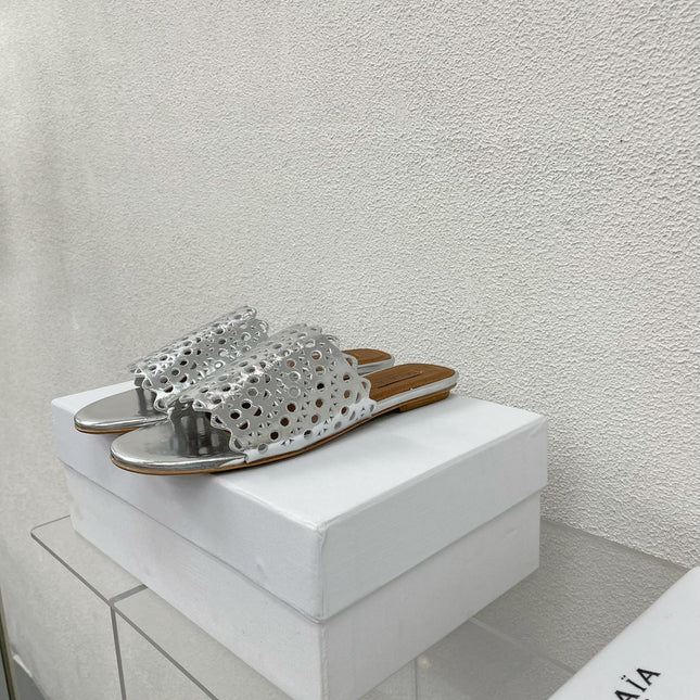 ALAIA VIENNE FLAT MULES IN SILVER LAMBSKIN