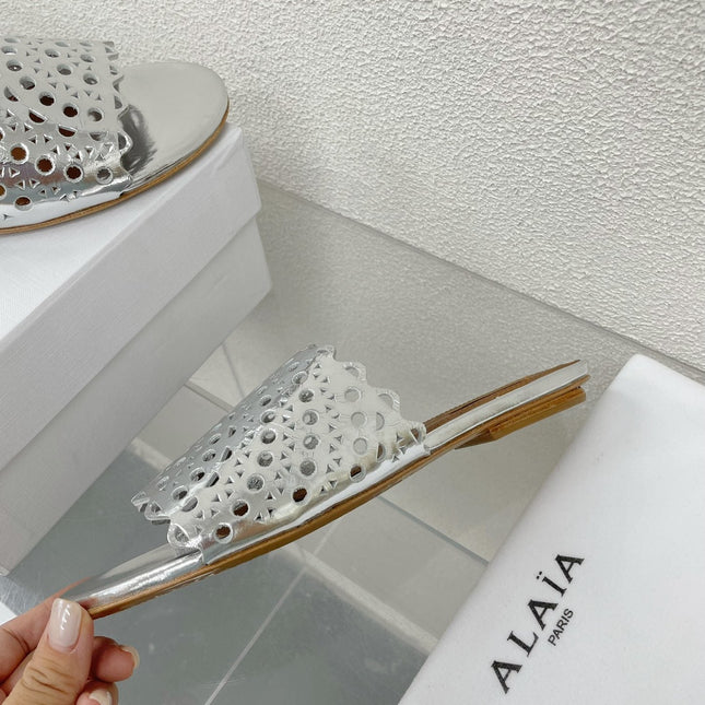 ALAIA VIENNE FLAT MULES IN SILVER LAMBSKIN
