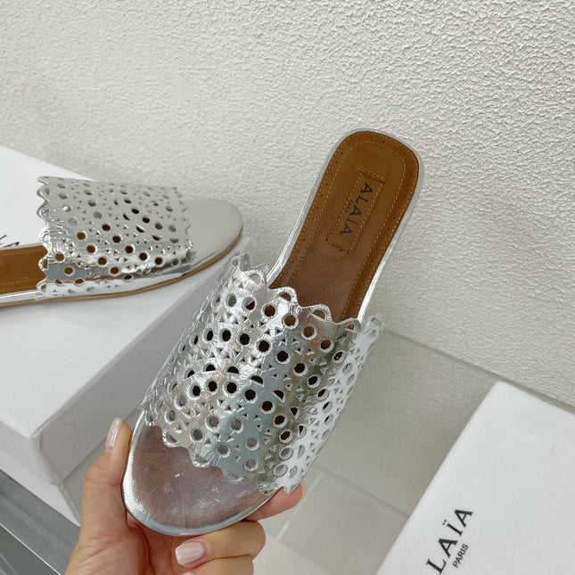 ALAIA VIENNE FLAT MULES IN SILVER LAMBSKIN