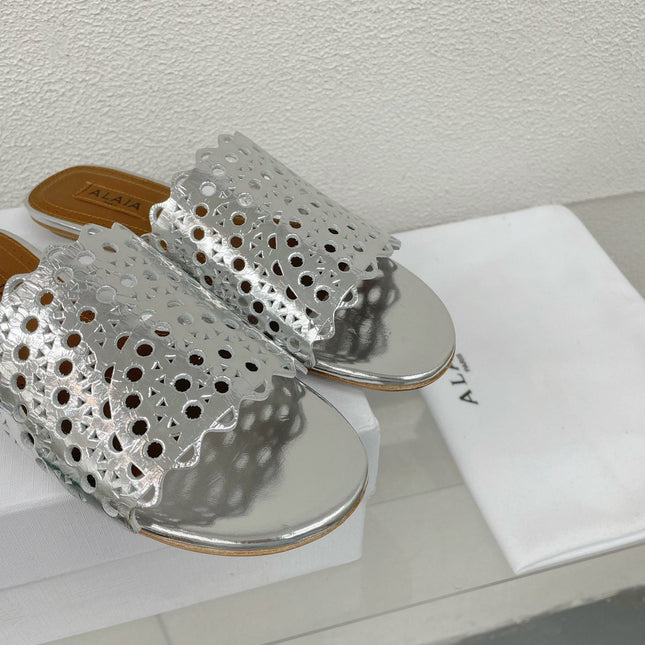 ALAIA VIENNE FLAT MULES IN SILVER LAMBSKIN