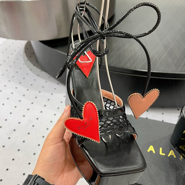 ALAIA BANQUET WEDGE SANDALS IN BLACK LAMBSKIN WITH RED HEART