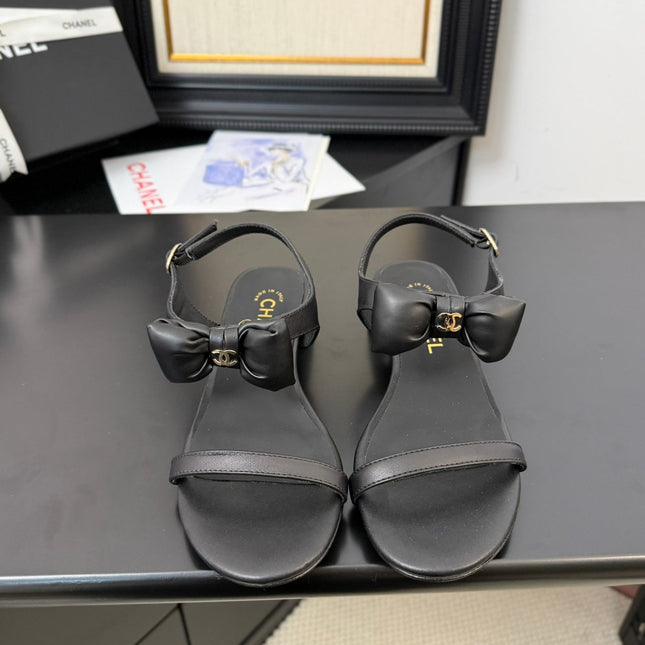 FLAT SANDALS IN BLACK CALFSKIN WITH BOW