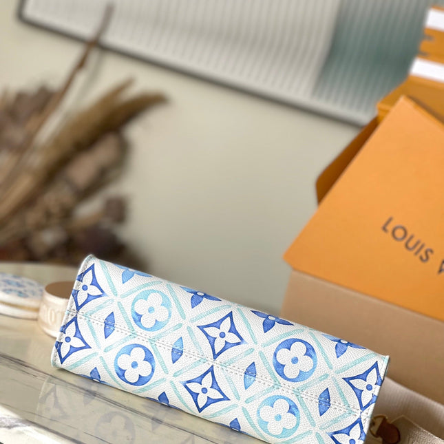 ONTHEGO EAST WEST 25 IN LAGOON BLUE MONOGRAM TILES CANVAS