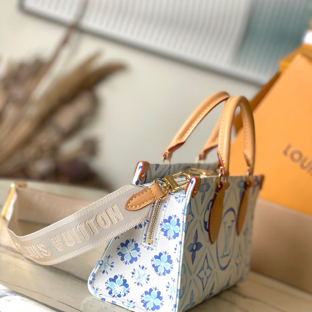 ONTHEGO EAST WEST 25 IN LAGOON BLUE MONOGRAM TILES CANVAS