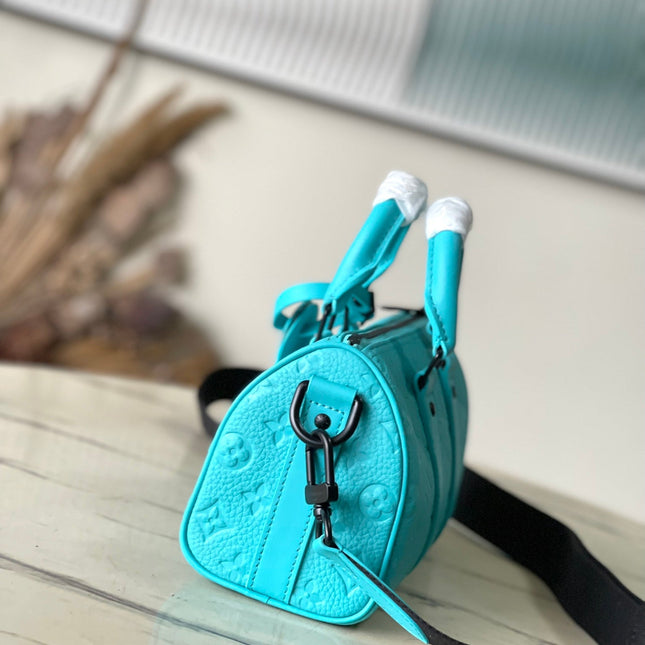 KEEPALL BANDOULIÈRE 25 IN TURQUOISE BLUE MONOGRAM EMBOSSED CALFSKIN