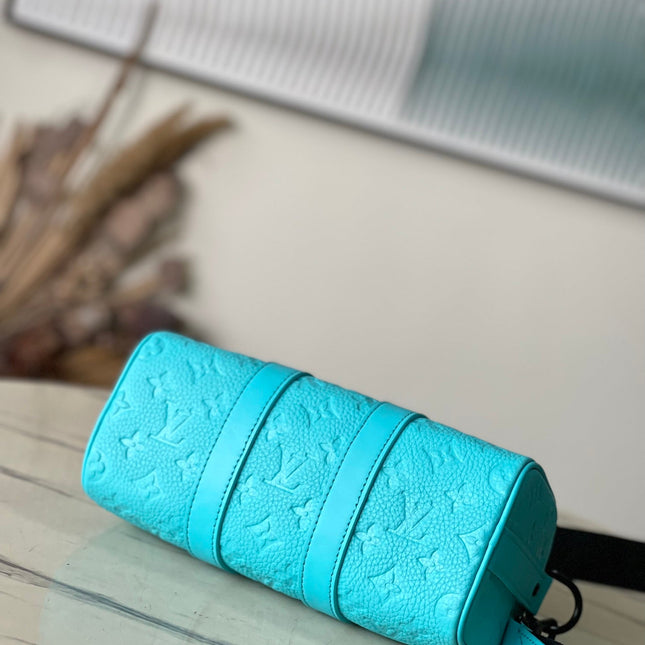 KEEPALL BANDOULIÈRE 25 IN TURQUOISE BLUE MONOGRAM EMBOSSED CALFSKIN