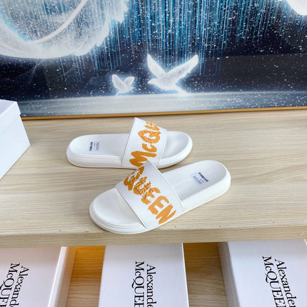 SLIDES SANDAL IN WHITE TPU WITH BOLD ORANGE LOGO GRAPHIC IN STRAP