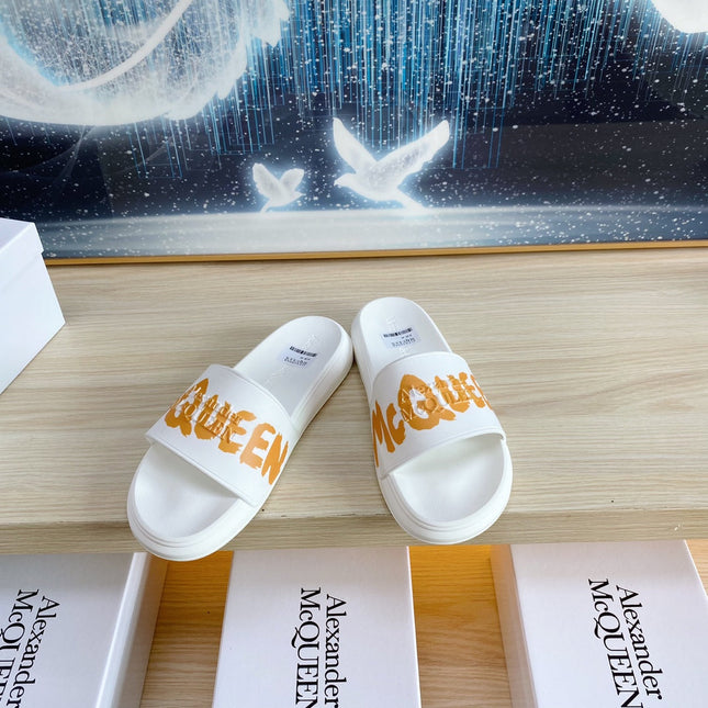 SLIDES SANDAL IN WHITE TPU WITH BOLD ORANGE LOGO GRAPHIC IN STRAP