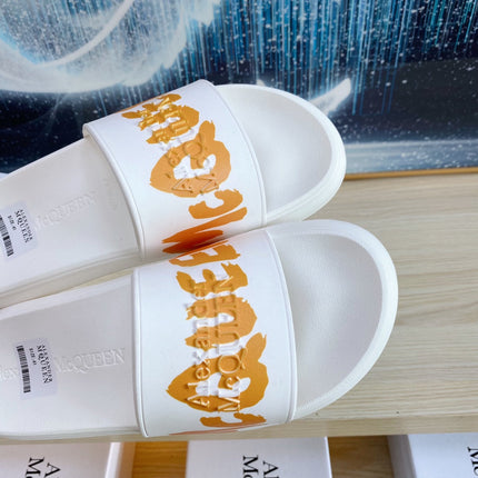 SLIDES SANDAL IN WHITE TPU WITH BOLD ORANGE LOGO GRAPHIC IN STRAP