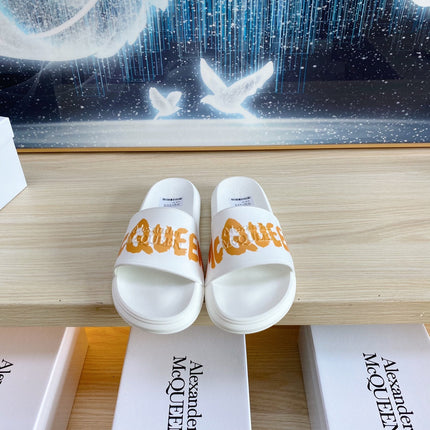 SLIDES SANDAL IN WHITE TPU WITH BOLD ORANGE LOGO GRAPHIC IN STRAP