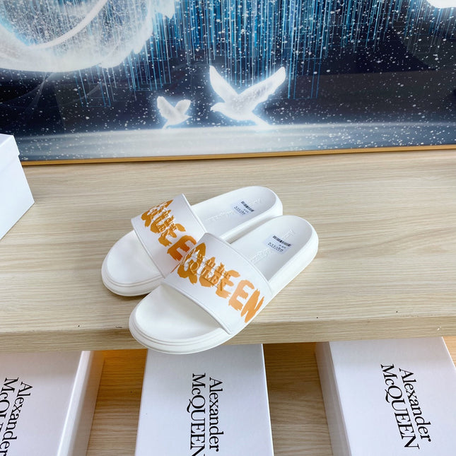 SLIDES SANDAL IN WHITE TPU WITH BOLD ORANGE LOGO GRAPHIC IN STRAP