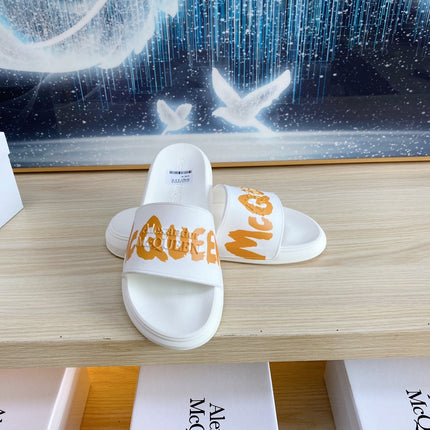 SLIDES SANDAL IN WHITE TPU WITH BOLD ORANGE LOGO GRAPHIC IN STRAP