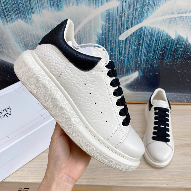 OVERSIZED SNEAKERS IN WHITE TEXTURED CALFSKIN BLACK HEEL BLACK LACES