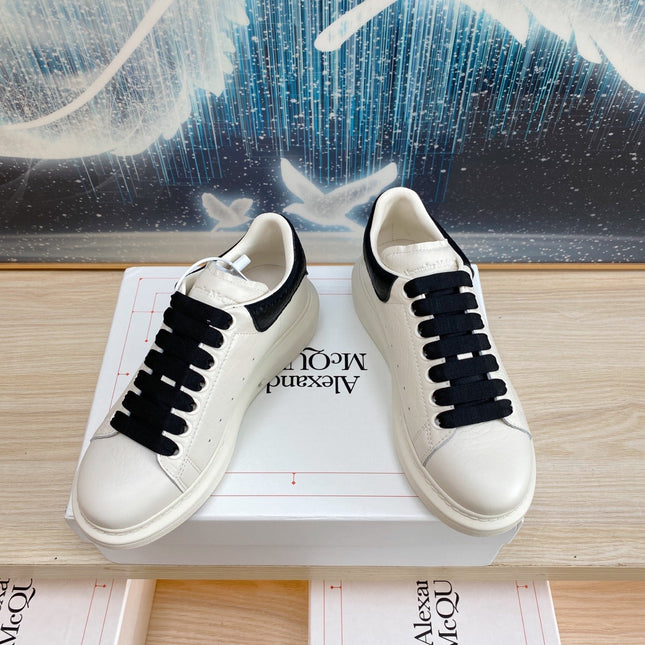 OVERSIZED SNEAKERS IN WHITE TEXTURED CALFSKIN BLACK HEEL BLACK LACES