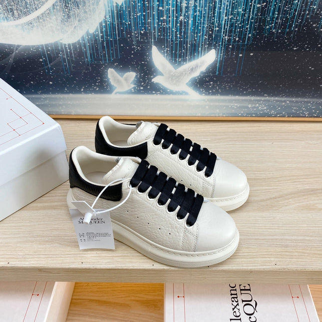 OVERSIZED SNEAKERS IN WHITE TEXTURED CALFSKIN BLACK HEEL BLACK LACES
