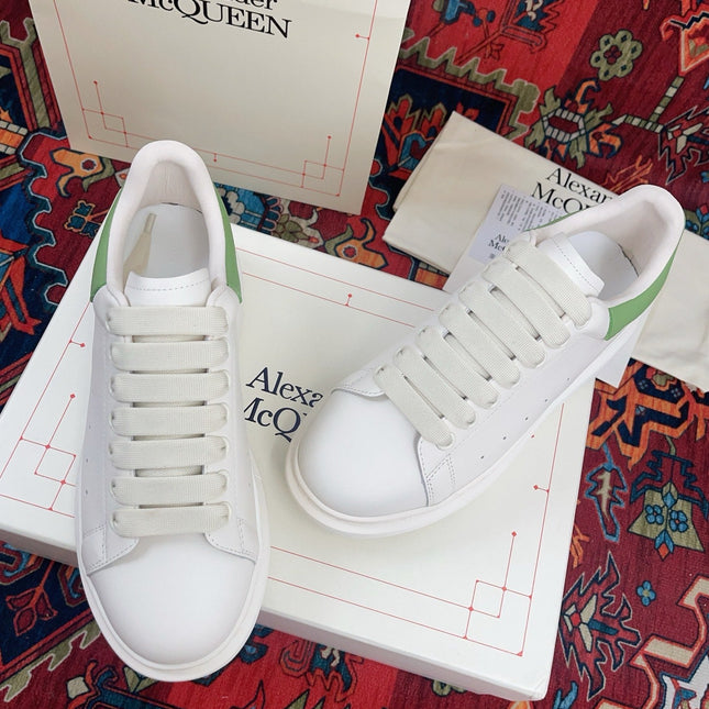 OVERSIZED SNEAKER IN WHITE CALFSKIN WITH EMBOSSED HUNTER GREEN HEEL TAB