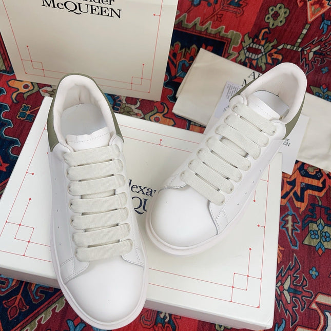 OVERSIZED SNEAKER IN WHITE CALFSKIN WITH EMBOSSED OLIVE GREEN HEEL TAB