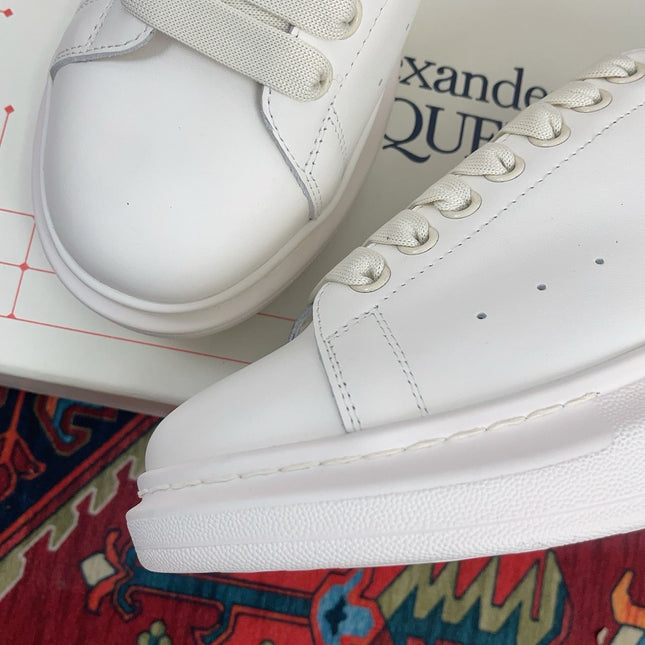 OVERSIZED SNEAKER IN WHITE CALFSKIN WITH EMBOSSED OLIVE GREEN HEEL TAB