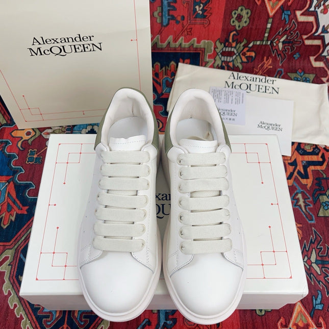 OVERSIZED SNEAKER IN WHITE CALFSKIN WITH EMBOSSED OLIVE GREEN HEEL TAB