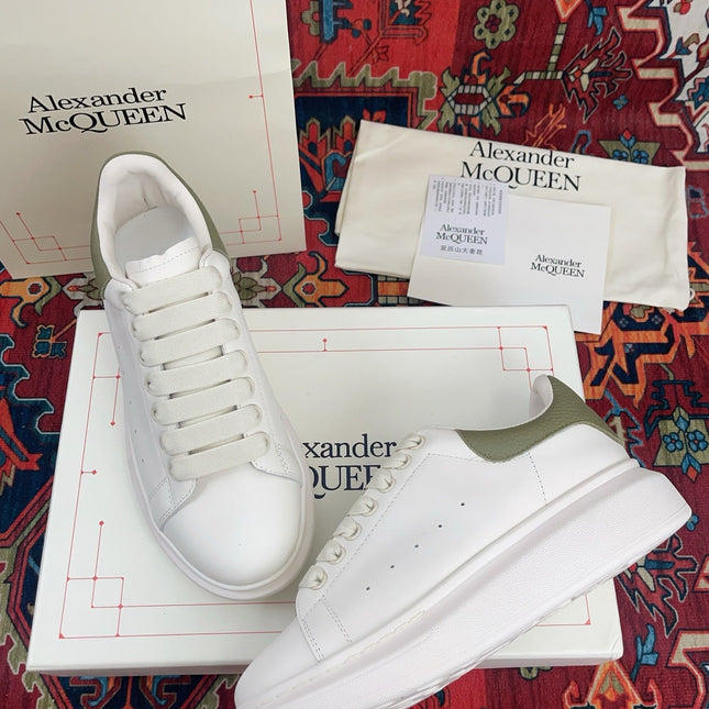OVERSIZED SNEAKER IN WHITE CALFSKIN WITH EMBOSSED OLIVE GREEN HEEL TAB