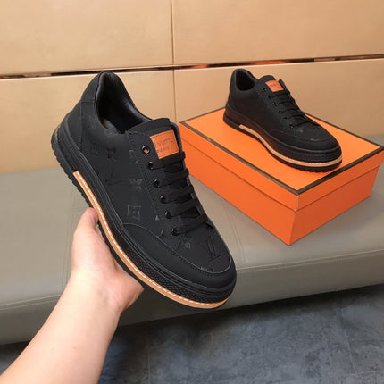LV TRAINER IN EMBOSSED BLACK SUEDE