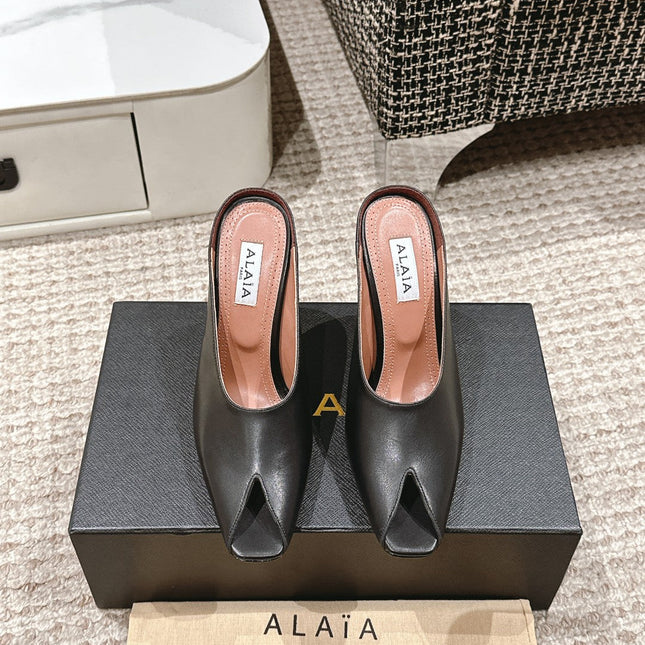 ALAIA SPIKE JEWEL MULES IN BLACK CALFSKIN