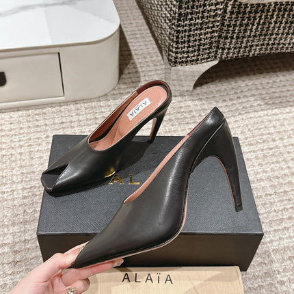 ALAIA SPIKE JEWEL MULES IN BLACK CALFSKIN