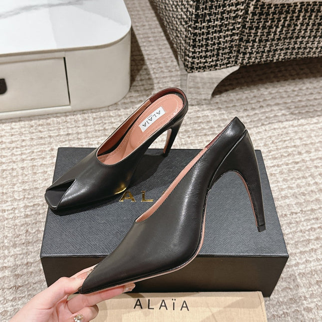 ALAIA SPIKE JEWEL MULES IN BLACK CALFSKIN