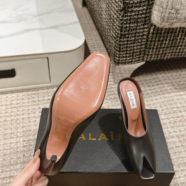 ALAIA SPIKE JEWEL MULES IN BLACK CALFSKIN