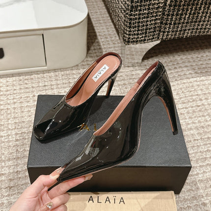 ALAIA SPIKE JEWEL MULES IN BLACK GLOSSY CALFSKIN